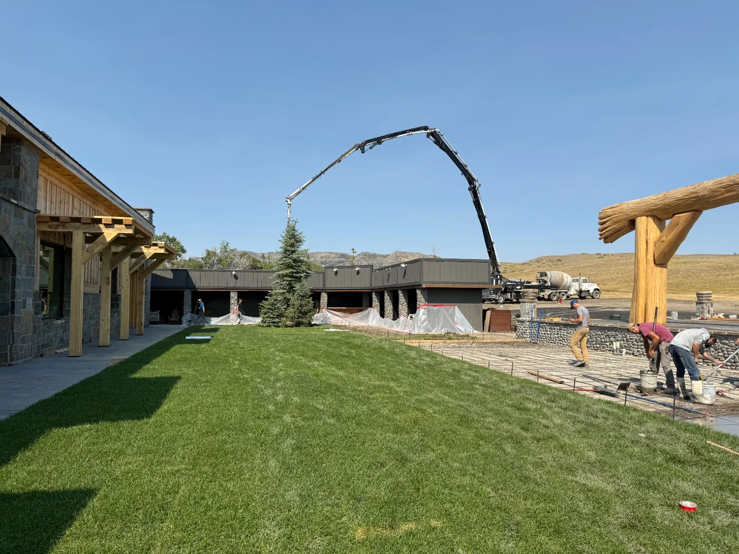 Concrete pumping operation at a landscaped residential property